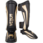 Espinilleras Venum Elite Standup - Negro/Oro